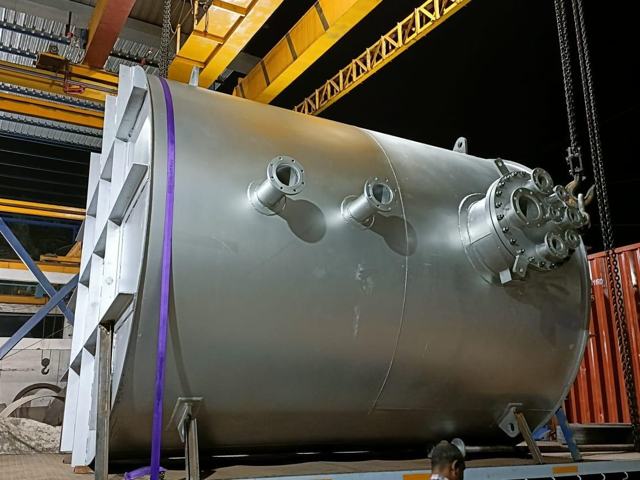 Stainless steel process vessel being loaded with EOT crane